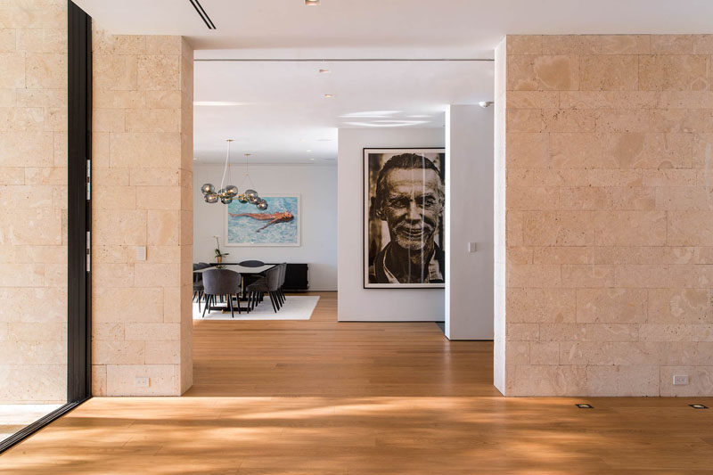 Large photos and artwork fill the otherwise bare walls in this modern house.