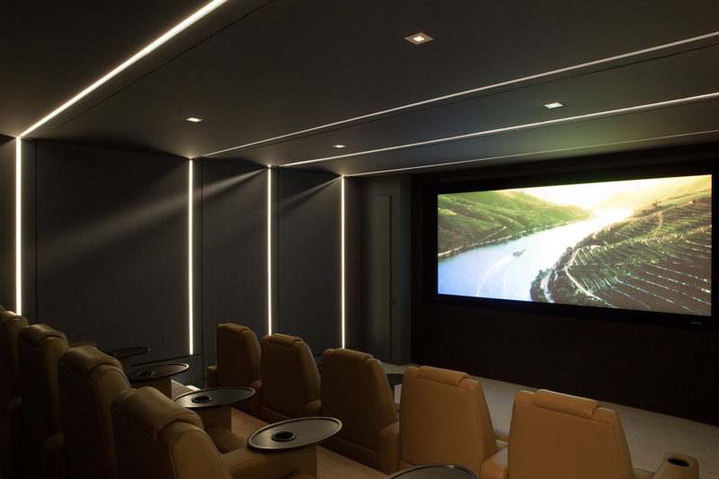 This modern home cinema has tiered seating, perfect for watching movies with friends and family.