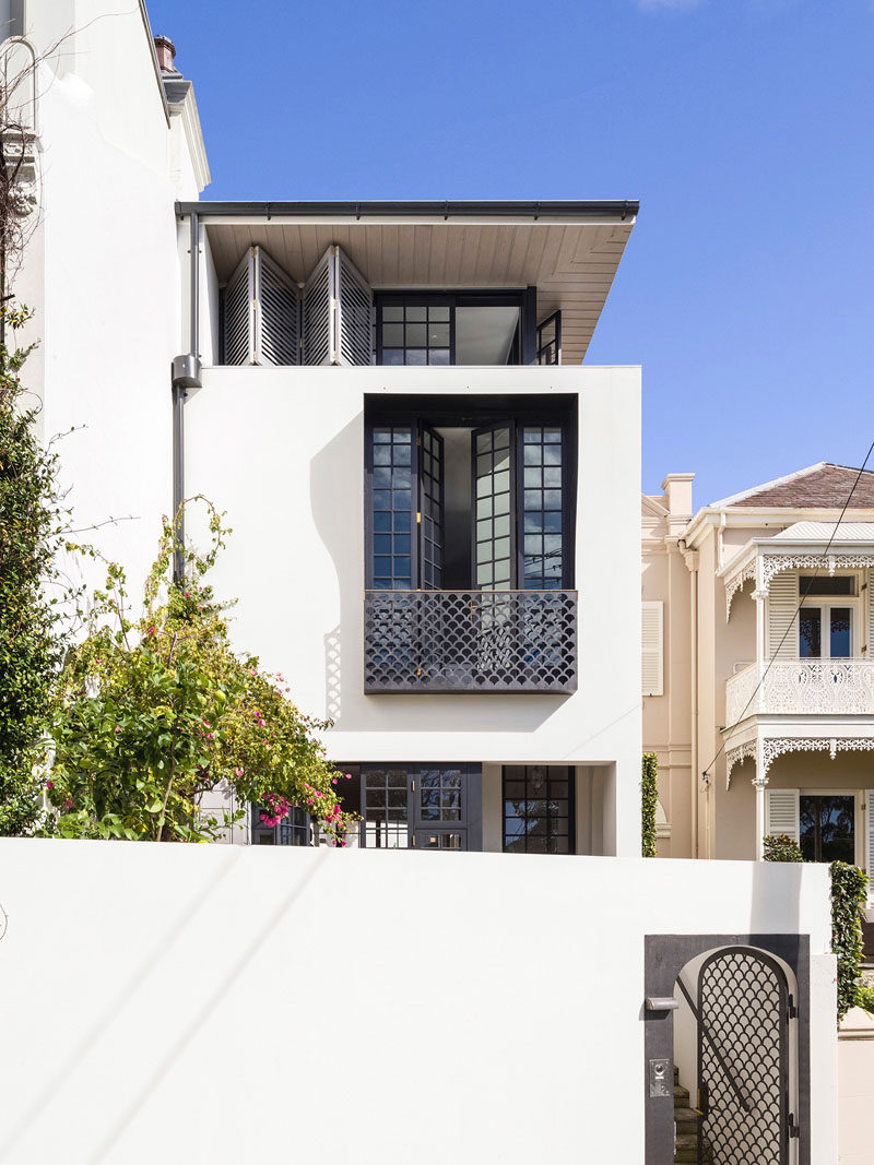 At the front of this renovated house, CNC cut steel plates in a fish scale pattern feature on the front gate and the Juliet balcony balustrade.