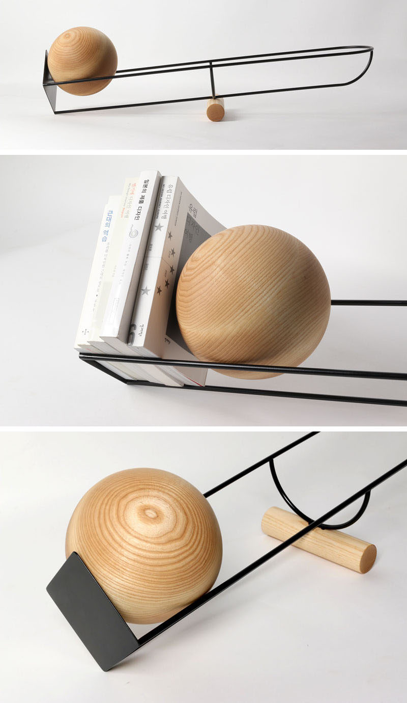 This simple and unique bookshelf is designed like a see-saw, with a wooden ball that rolls depending on where the weight on the shelf is.