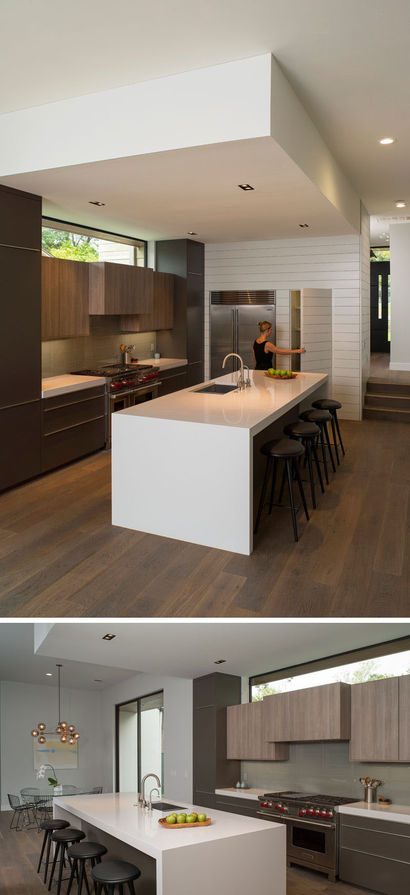 In this modern kitchen, the large white island with seating has plenty of room for guests to sit and chat, and a pantry is hidden sits beside the fridge.