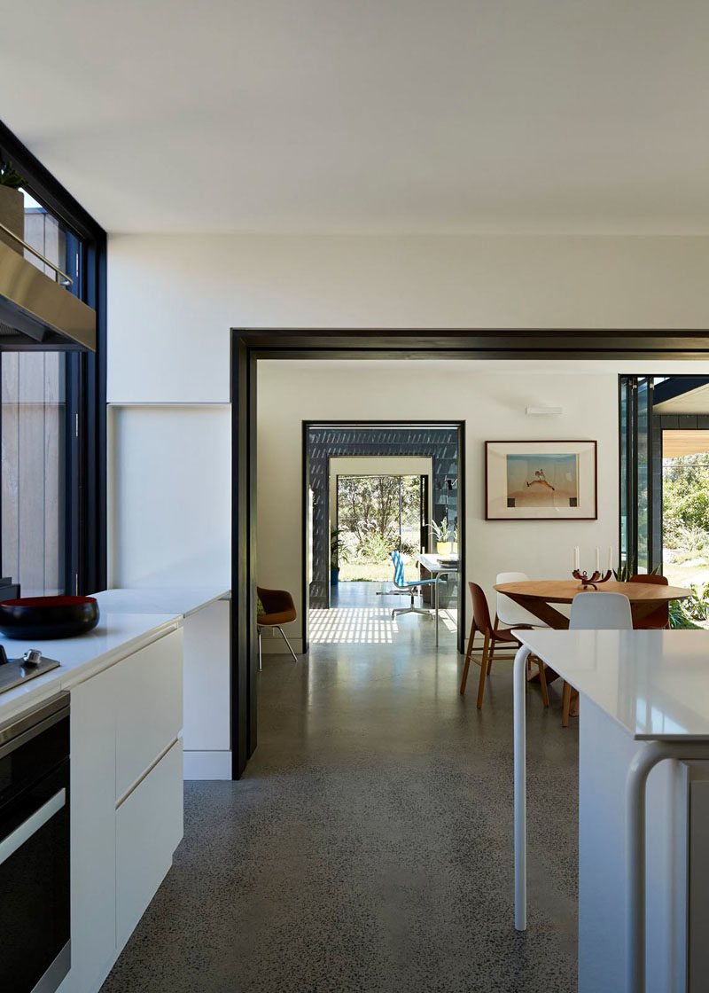 This modern house has an open hallway that lets you look from the kitchen right to a granny flat (apartment) at the end of the house.