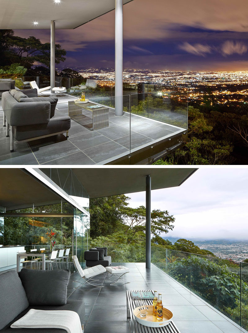 This architecturally designed entertaining room has a covered outdoor space with a couple of seating options. Glass safety railings provide an unobstructed view of the city below.