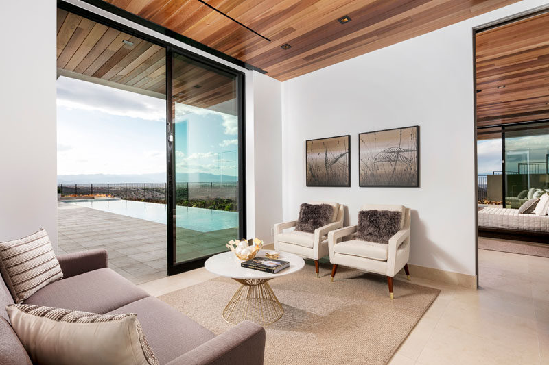 This private living room just off the master bedroom, has a wood ceiling and opens up to the pool deck outside.