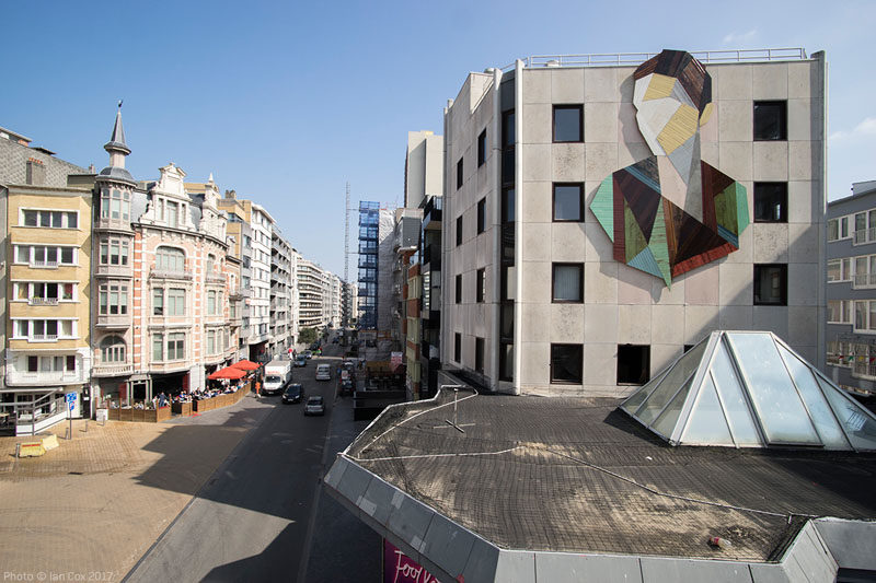 Artist Stefaan De Crook (also known as Strook), has created a large recycled wood mural on the side of a building in Ostend, a coastal city in Belgium.