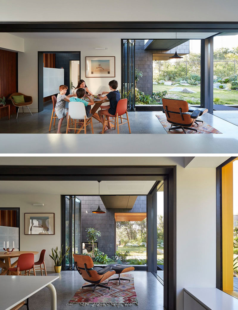 The dining area of this modern house opens up directly to the backyard.