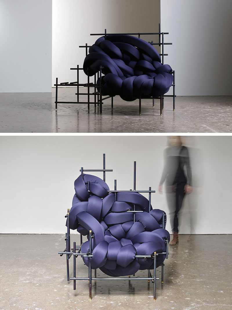 American designer Evan Fay, has created the Lawless Chair, a sculptural oversized seat made from steel rods and woven strips of dark blue upholstered cushions.