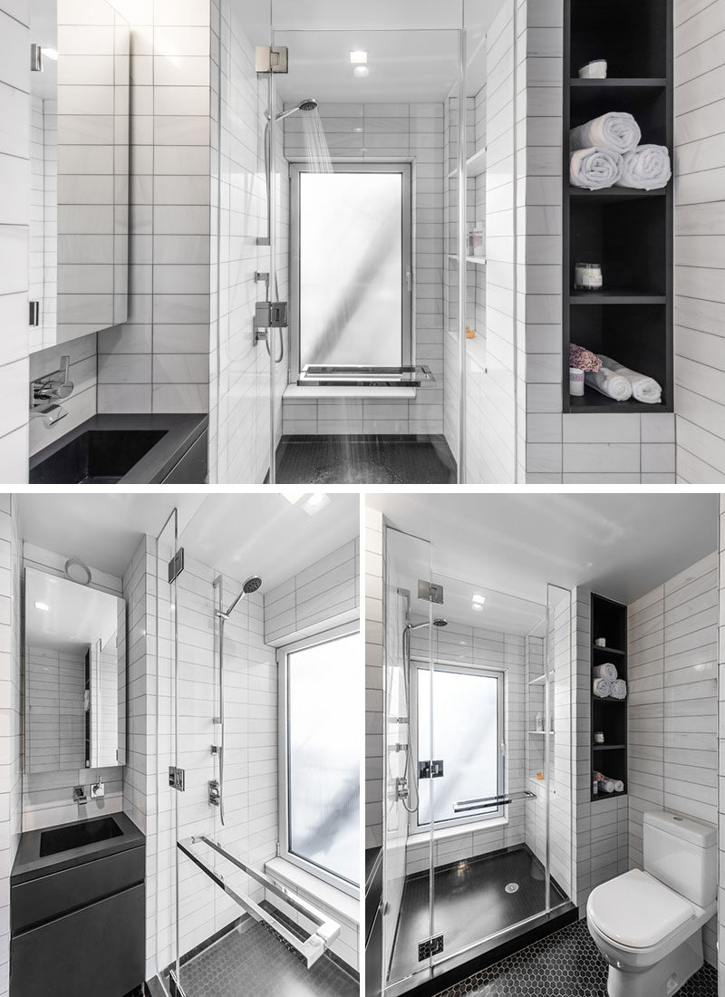 This small bathroom has a walk-in glass enclosed shower, and a small vanity area. White tiles have been used to keep the bathroom feeling spacious, and black open shelving adds some additional storage to the small space.