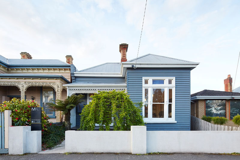 This turn-of-the-century weatherboard home in Australia, has a contemporary wooden house extension, that is hidden from view from the street.