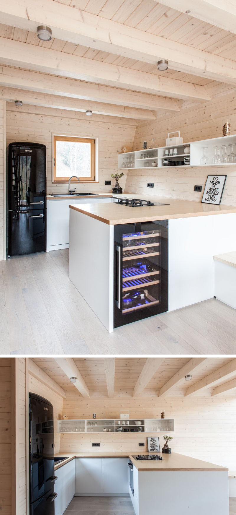 This light wood kitchen has a u-shaped layout with white hard-ware free cabinets, a wood countertop and open shelves that float on the wall. Black elements, like the fridges and sink and artwork, are also featured.