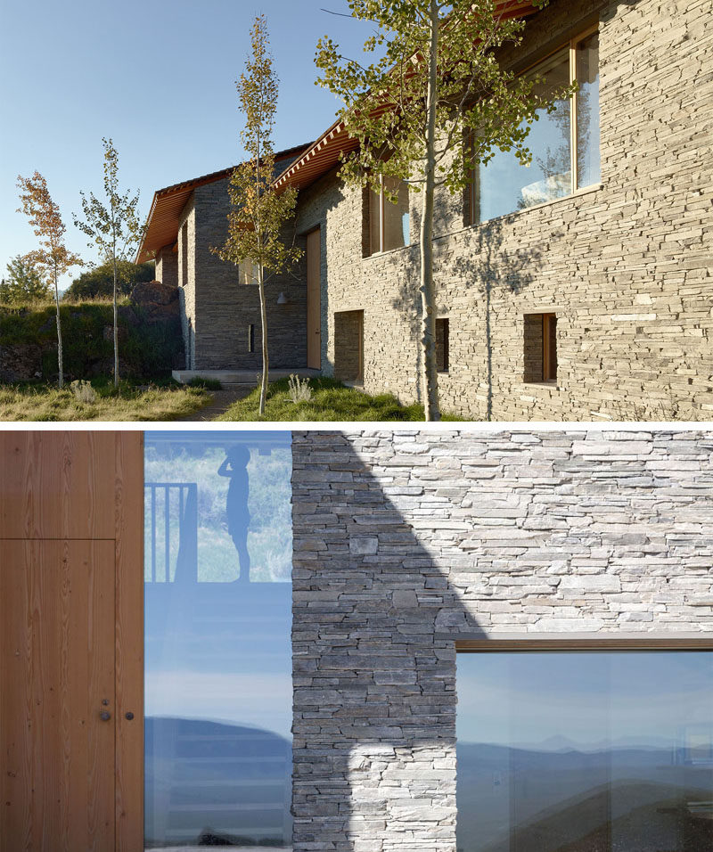 The design of this modern house uses materials like stone, wood, plaster and glass, and is inspired by both European chalets and American cabins.
