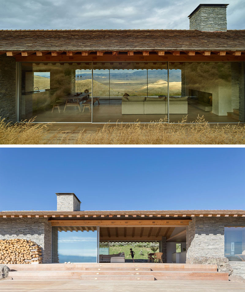 Large expanses of windows used in the design of this modern house, perfectly frame the view of the valley below and the mountains in the distance.