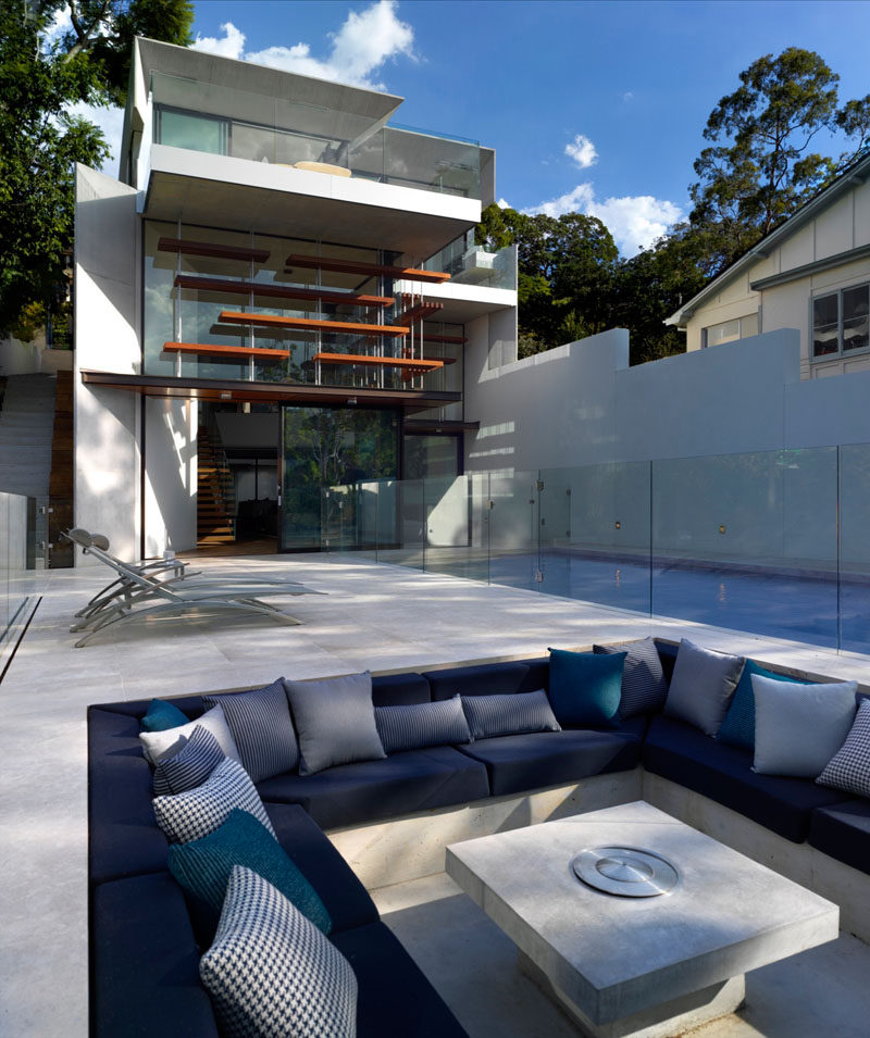 This modern house with multiple levels, has a swimming pool, outdoor deck, and a sunken lounge.