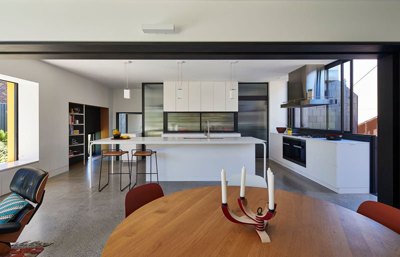 This modern kitchen has white cabinets and a large island with plenty of space for extra seating.