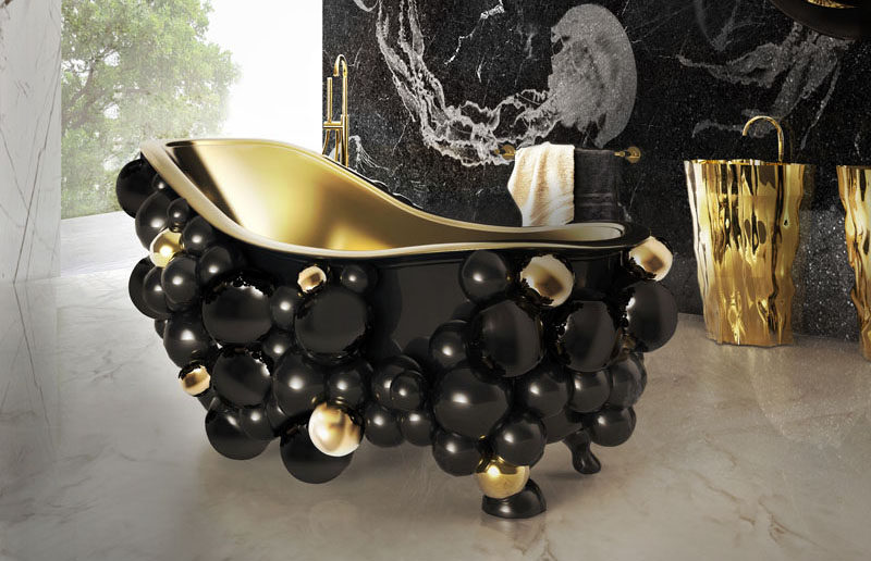 Designer Joaquim Paulo has designed the Newton Collection for Maison Valentina, that includes a bathtub and washbasins that have a black bubbly exterior and a rich gold interior.