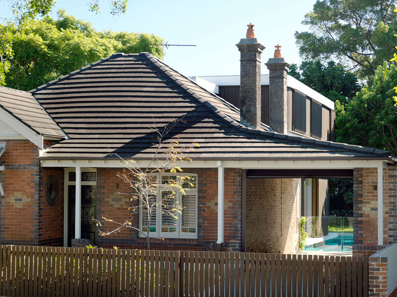 A verandah to the side of this 1910's brick house was extended to become a carport, and beyond, a swimming pool and additional living spaces were created.