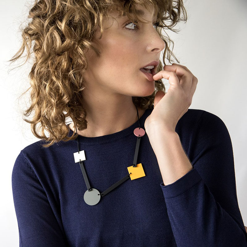 Colored circles and squares connected by black rectangles, give this necklace a distinctive geometric look that's both simple and artistic. #ModernJewelry #Fashion #Style