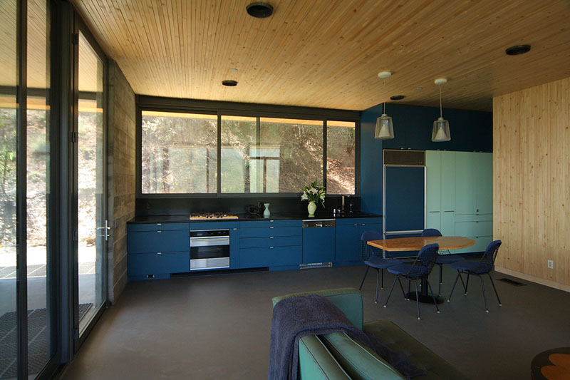 Two shades of blue have been used on the cabinets of this kitchen and tie in with the other uses of blue throughout the rest of the interior.