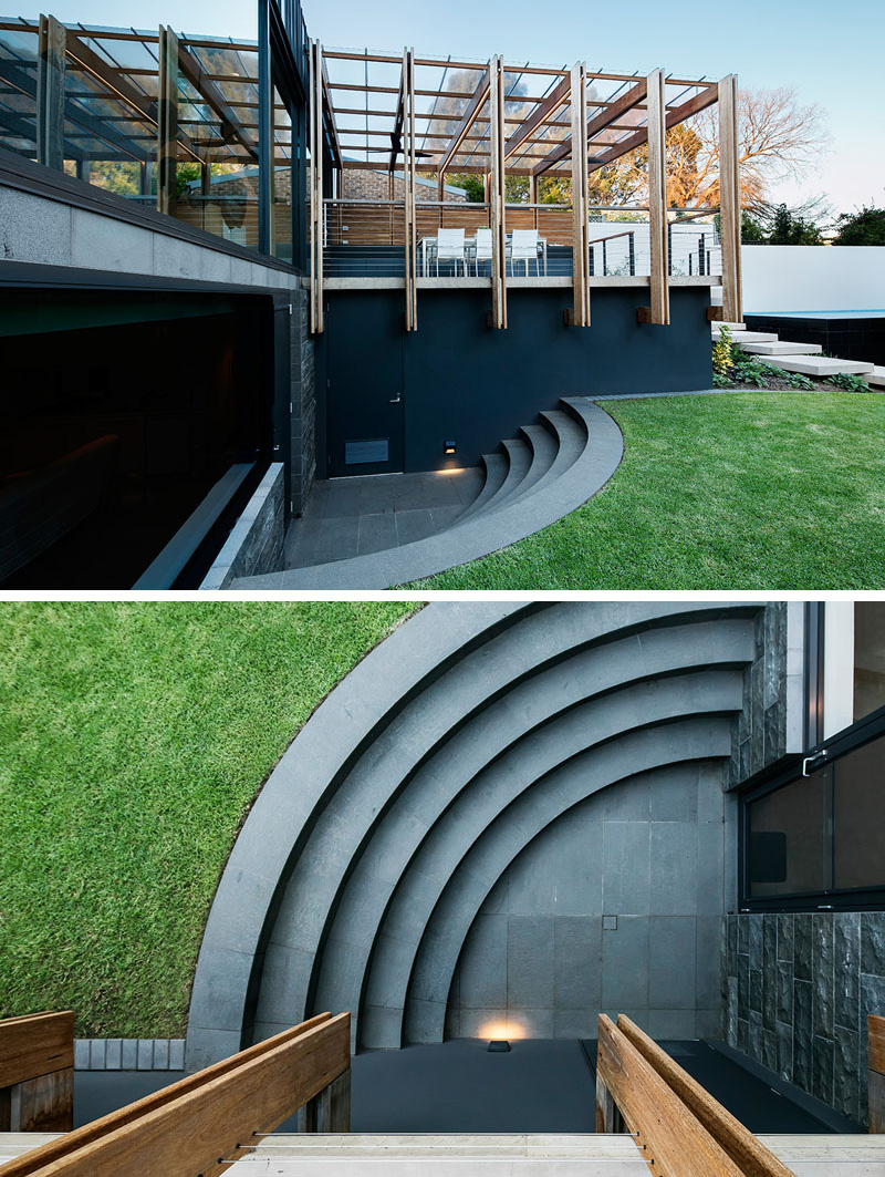 Curved stone steps lead from the lower level of this modern house extension to the backyard. The location of the steps prevents them from being a hazard when the kids are playing and the way they curve into the side of the home makes them a unique design detail.