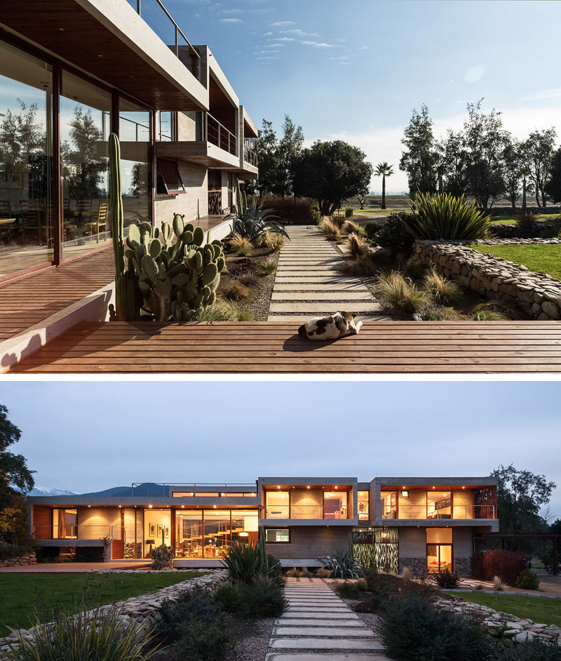 Two strips of concrete pavers create paths at the back of this modern home defining various sections of the yard.