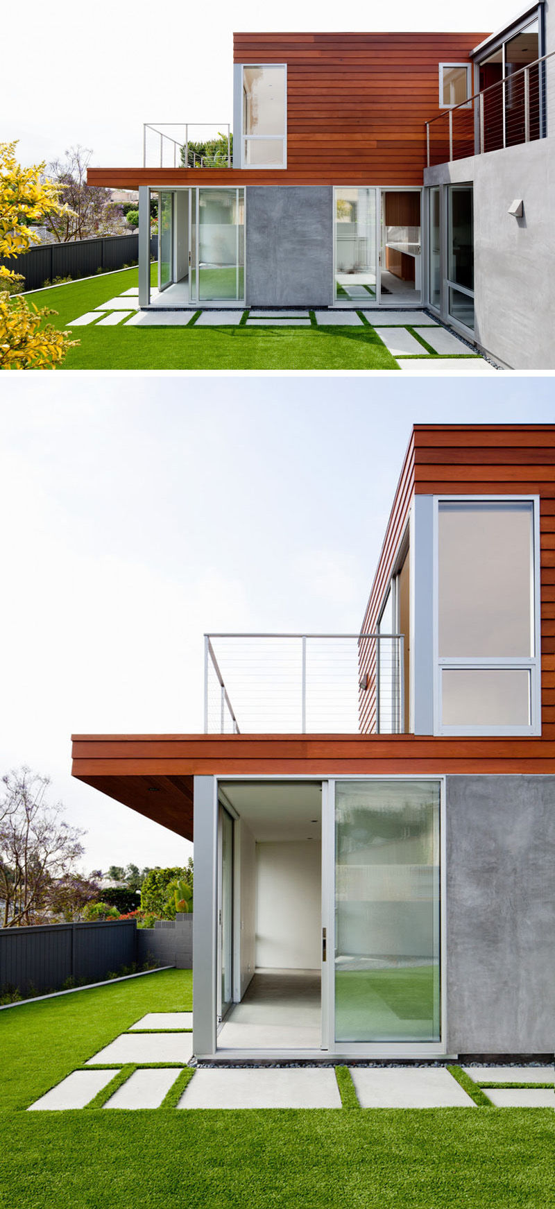 Concrete pavers go around the back of this modern house, connecting the various spaces and creating a manicured landscape.