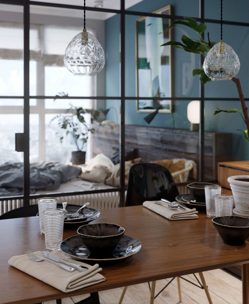 In this small apartment, black framed glass walls have been used to separate the bedroom from the rest of the apartment. #GlassWalls #Interiors #InteriorDesign