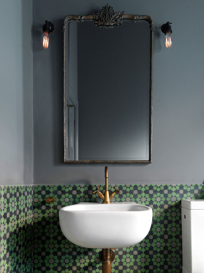 In this bathroom, bronze accents and grey walls have been paired with colorful patterned Encaustic tiles from Europe.