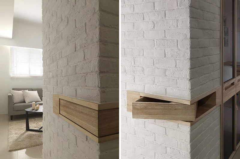 This white painted brick wall has a small wood section that wraps around the corner of the wall. This wood section can actually be pushed out and becomes a secret hiding space.