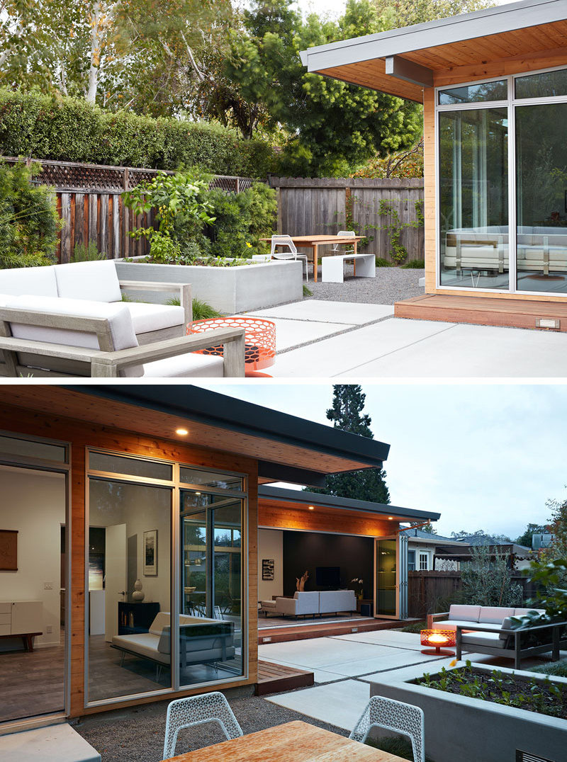 Tucked beside the entertaining patio is an outdoor dining area set up with a wood dining table and bench seating.