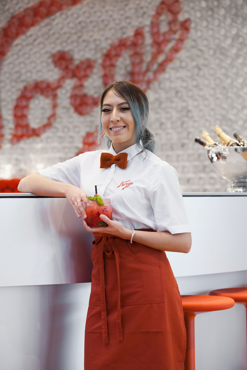 In this modern airport bar, the staff uniforms match the color palette of the interior design.