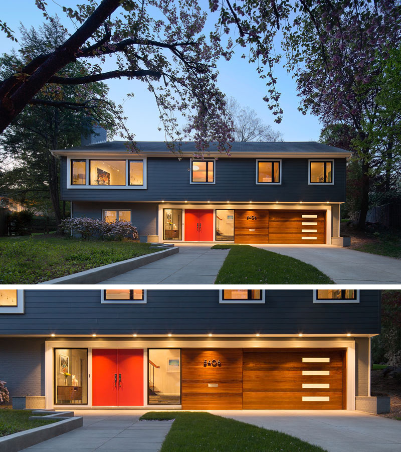 Between two floor-to-ceiling windows, the large bright red double door stands out amongst the exterior of this modern home.