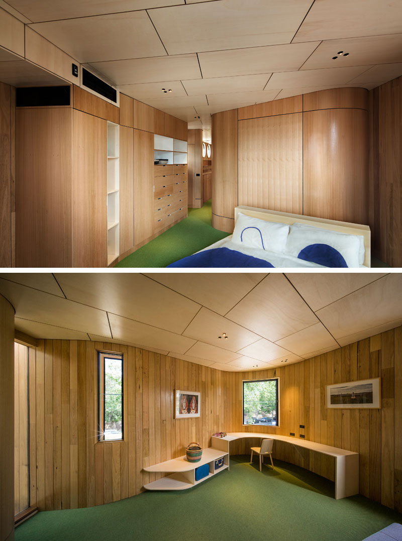 This modern bedroom has green flooring and plenty of custom designed built-in wood cabinets with additional curved wood detailing for the walls.