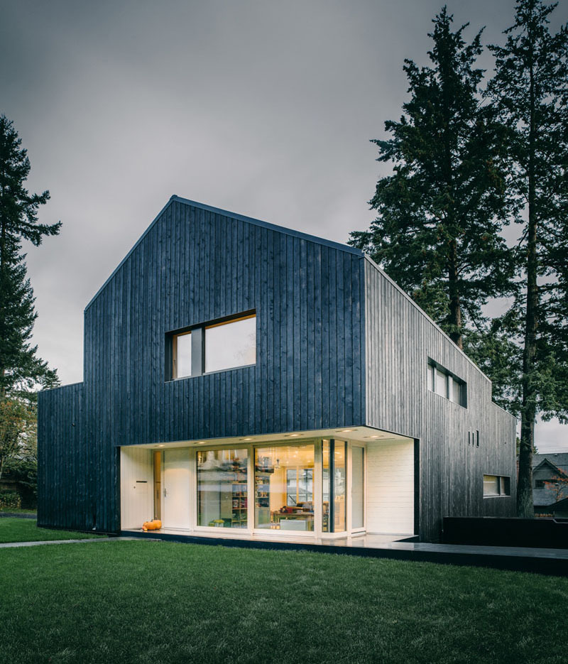 Burnt, blackened wood panels cover the entire exterior of this modern forest home. #ModernBlackHouse #BlackHouse #BlackExterior #BlackArchitecture