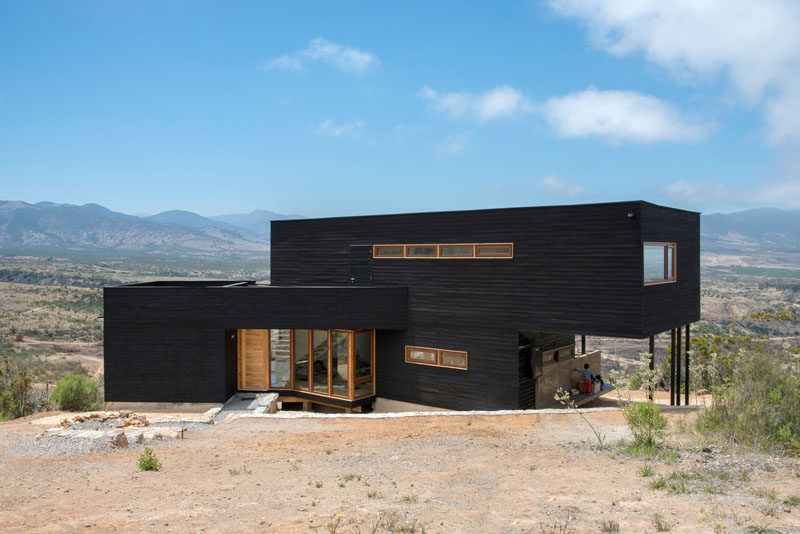 Architect Thomas Löwenstein has designed this modern black house near the beach town of Los Molles in Chile, that sits on a half acre field looking out to the mountains on one side and views of the beach on the other.