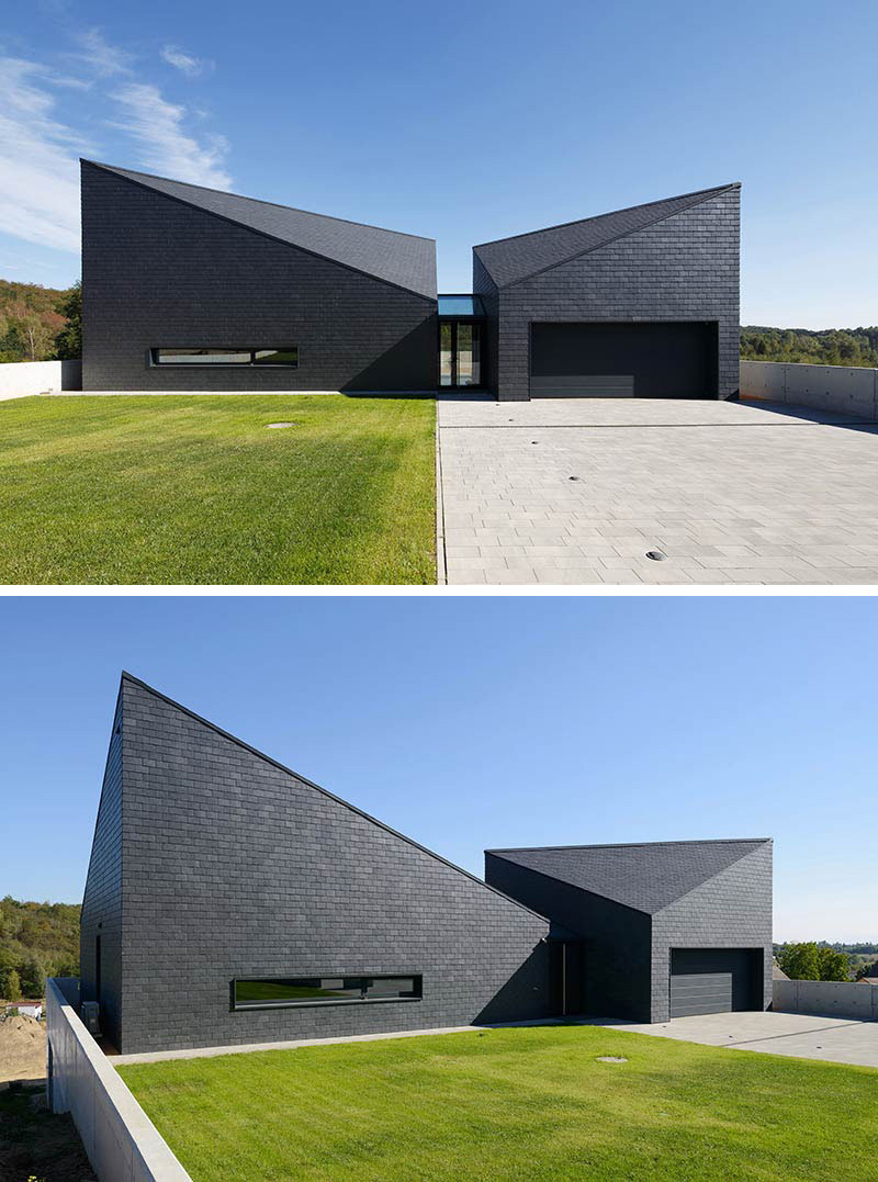 This black modern home has a futuristic look to it thanks to the angles created where the roof of the house meets the sides. #ModernBlackHouse #BlackHouse #BlackExterior #BlackArchitecture