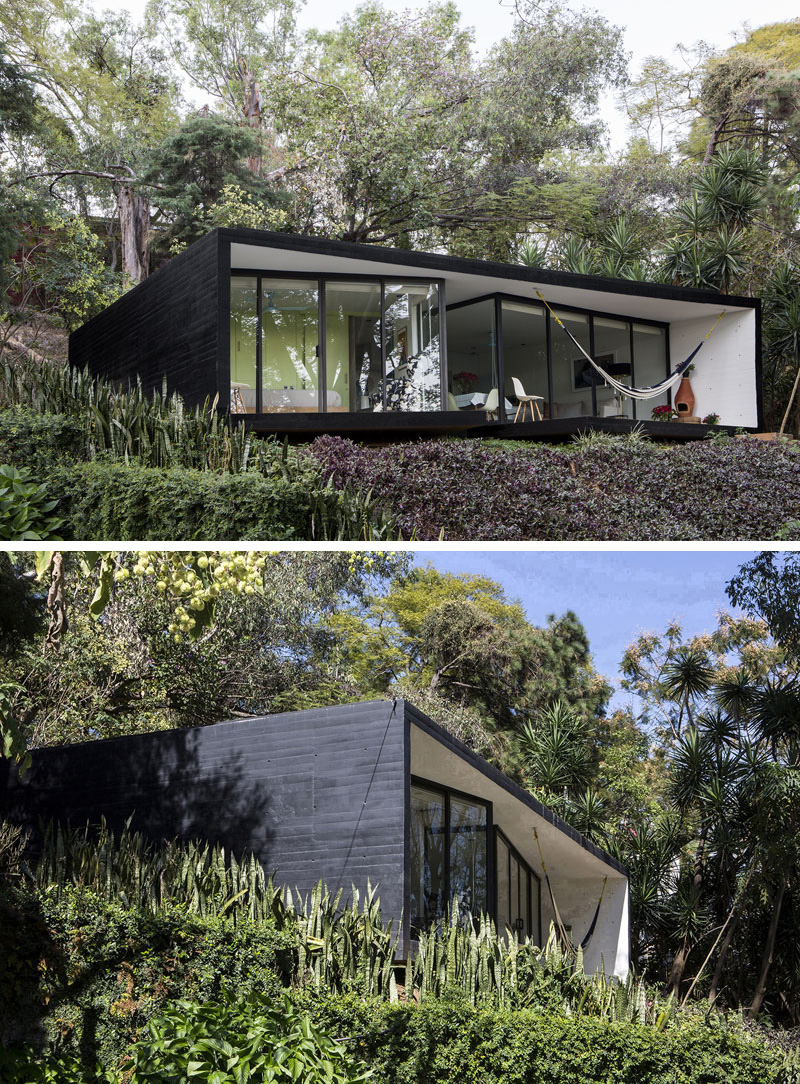 This small house has been covered in black siding to give it a modern feel and conceal it in the dark forest around it. #ModernBlackHouse #BlackHouse #BlackExterior #BlackArchitecture