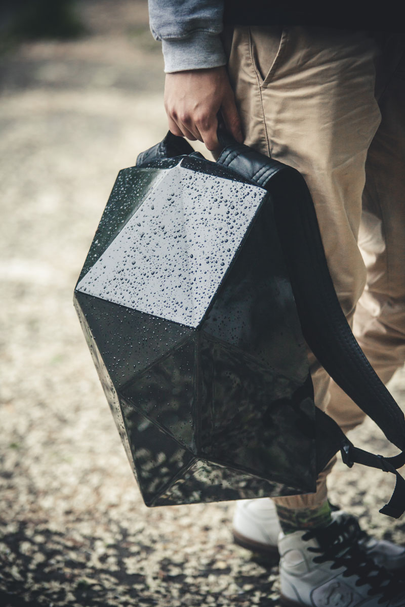 When the hard shell is on this modern backpack, the glossy polystyrene material keeps the bag protected from the rain and other damage. 