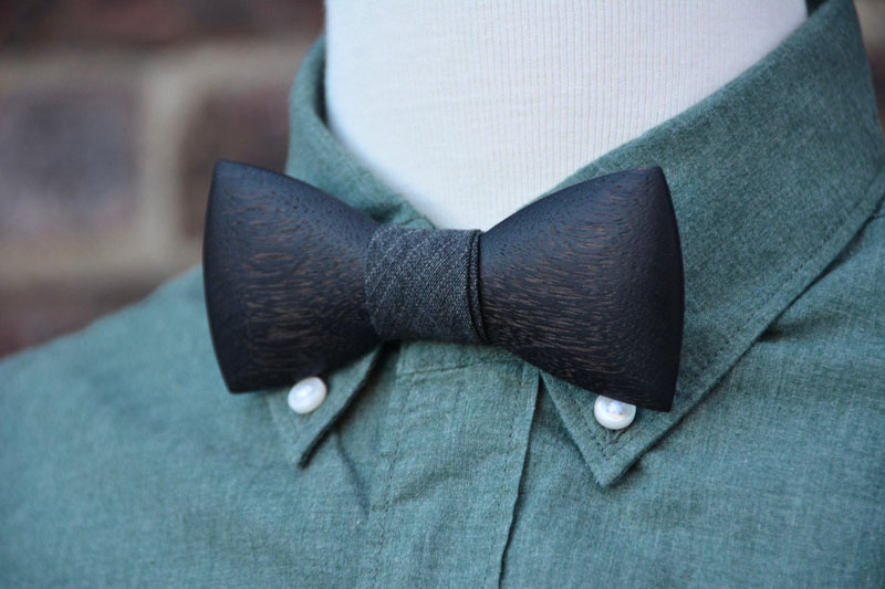 This modern wood bow tie has a dark grey finish, giving it an almost black look, but still allows the wood grain texture to come through