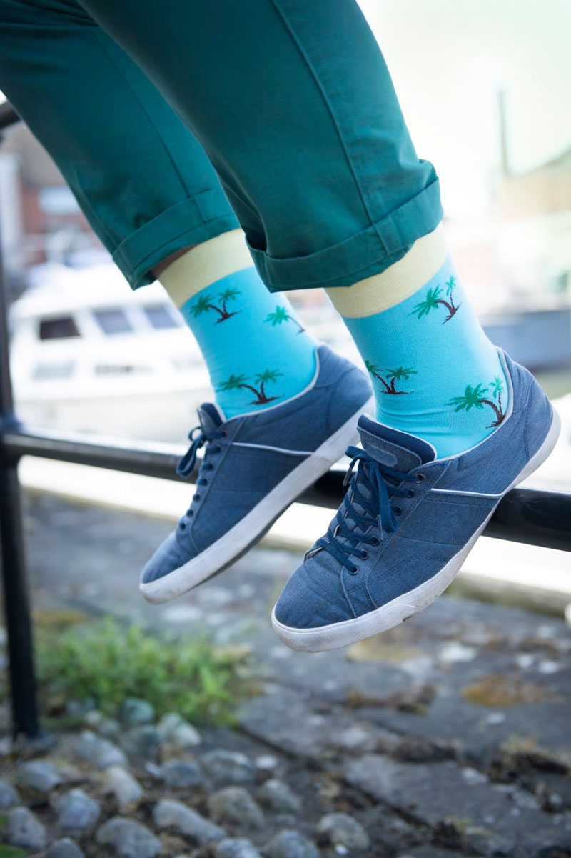 These modern neon blue socks with palm trees reflect a laid back lifestyle.