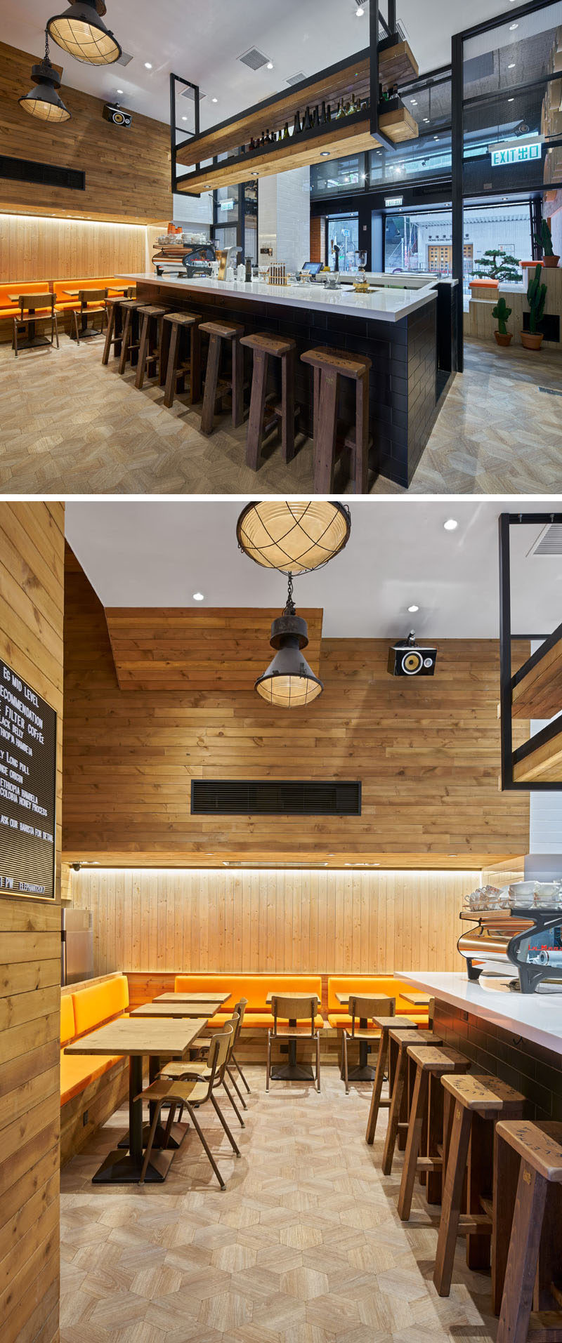 In this modern coffee shop, wood stools line the white topped, black brick coffee bar, while multiple wood tables with wood chairs and orange cushions provide more seating. Antique light fixtures and lighting hidden within the wall keep the space bright. Above the coffee bar, a hanging wood shelf with lighting provides extra storage space.