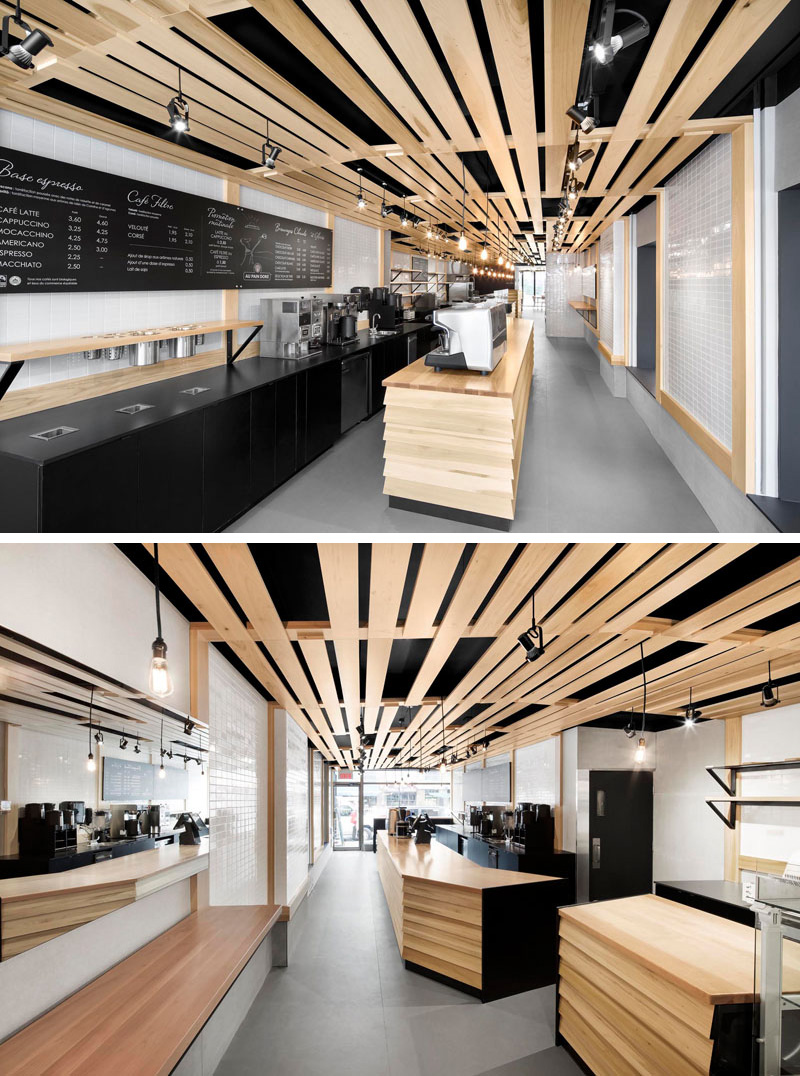 NatureHumaine designed Au Pain Doré, a modern cafe and bakery in Montreal, Quebec, featuring black cabinetry and light wood slats that pay tribute to the lattice of traditional wood bread baskets