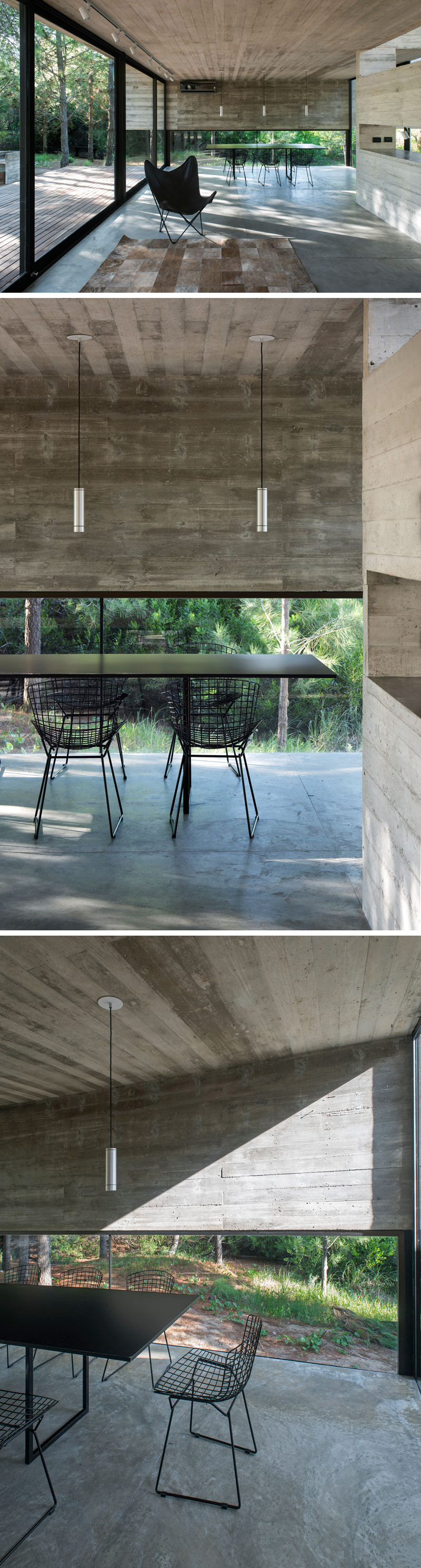 This modern dining room has three black and silver minimalist pendant lights which anchor the black dining set in place. A window that travels half way up the wall gives a glimpse of the forest.