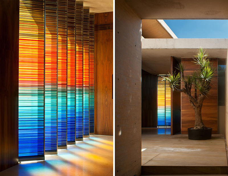 In this modern home, warm decorative glass accents create colorful patterns throughout the hallway that complement the wood used in the interior. 