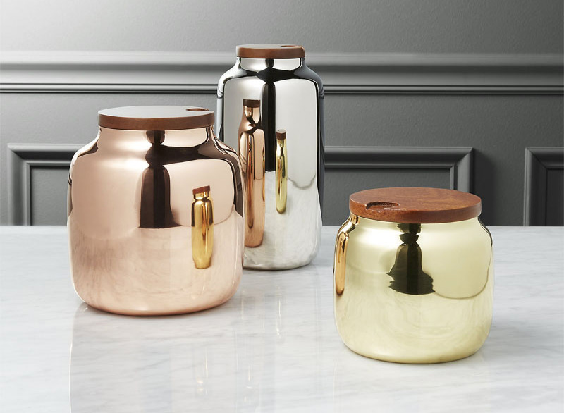 With gold, silver, and copper finishes, these stainless steel canisters are perfect for the modern kitchen. A gorgeous, notched mango wood lid allows for easy access to the contents inside. #PantryIdeas #StorageIdeas #KitchenStorage #KitchenJars #ModernJar #ModernCanister #PantryJars