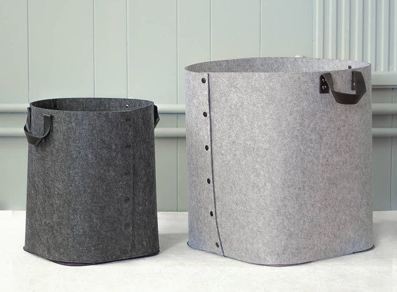 Made from reinforced felt, these grey laundry baskets have faux leather black handles. With the ability to collapse, these baskets are perfect for toting things around, and can be stored after use.