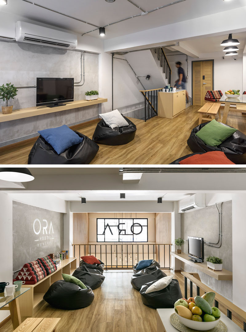 On the first floor of this modern hostel in Bangkok, there's a communal lounge and dining area set up with bean bags and benches. The lounge also looks over the reception area below.