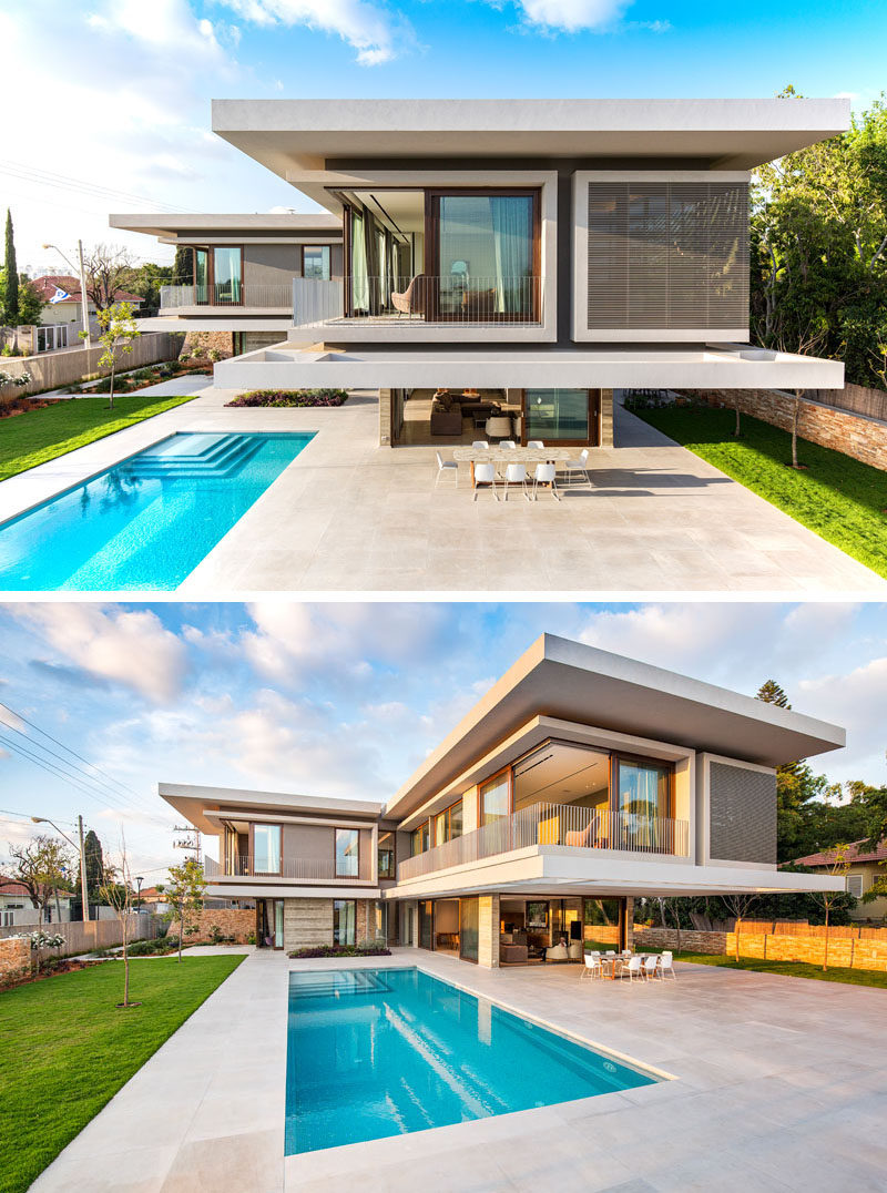 This modern house in Israel has a large patio area with an outdoor dining table. It sits underneath a section of the house that's cantilevered out to provide shade and add a dramatic touch to the design of the house.