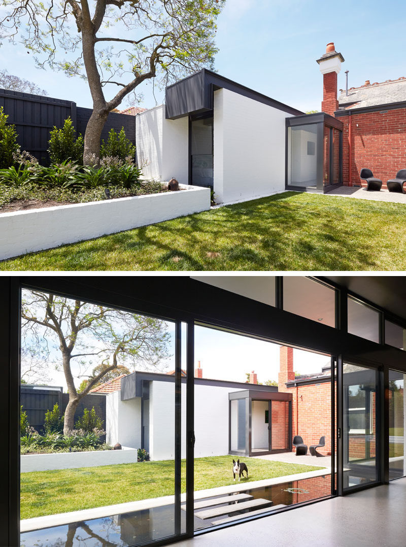 This old brick house has a modern extension, with the 'pod' on the left home to two new bedrooms, with one of them looking out to the garden through a vertical window.