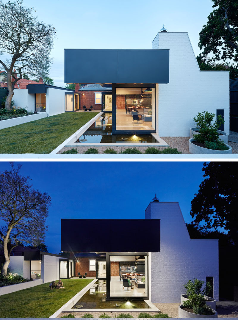 This brick house has two modern 'pod' extensions that are separated by a garden and small patio area, with them both having flat roofs which extend to provide shade from the hot afternoon sun. 