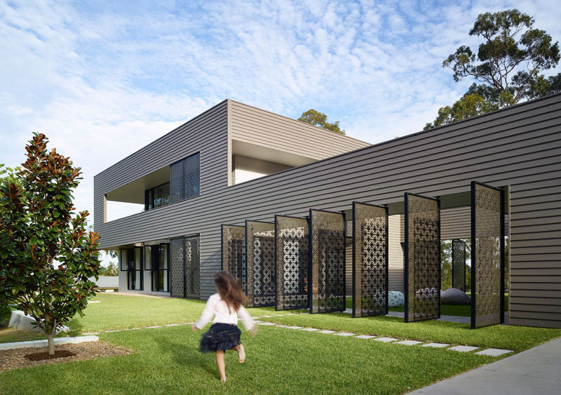 Jamison Architects have designed this Australian house that features two pavilions connected by a grassy courtyard and decorative laser cut screens.